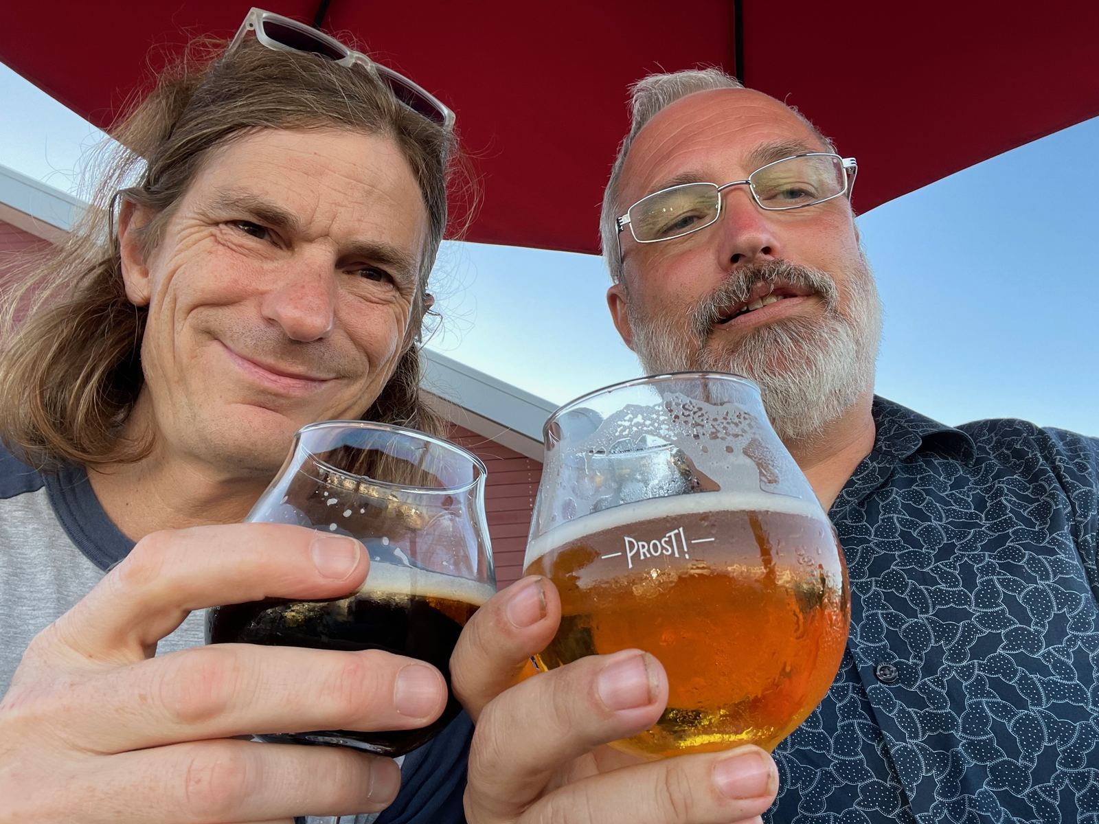 Alan and a friend toasting with craft beer glasses